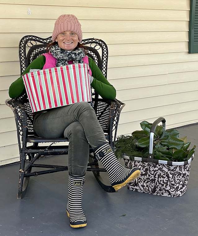 On the porch with a basket of fresh magnolia and greenery