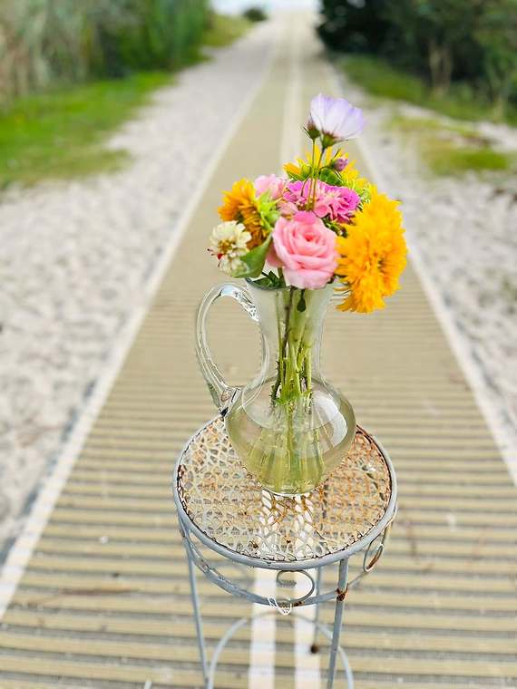 Sunflowers, zinnias & roses in a glass pitcher