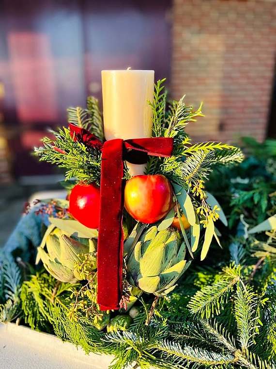 Holiday candle centerpiece with fresh greenery