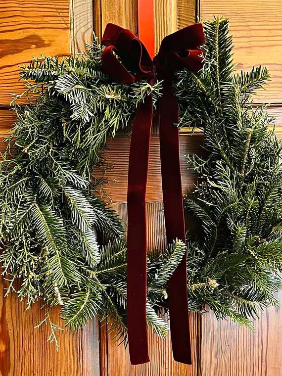 Fir wreath with a burgundy velvet bow
