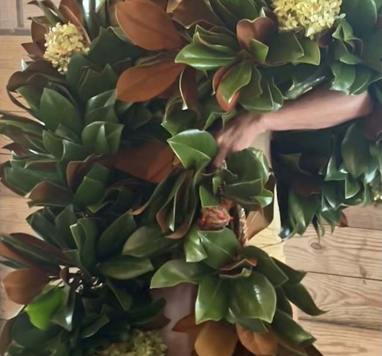 Armfuls of fresh magnolia garland with dried hydrangea in the barn