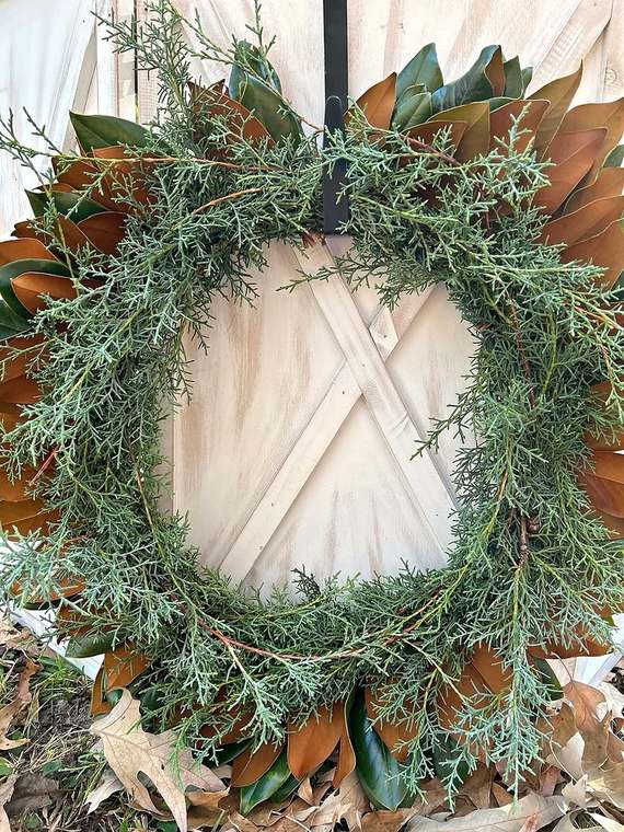 Magnolia & juniper wreath on a white barn door