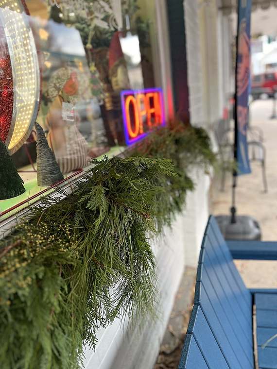 Fresh evergreen garland along a storefront window box