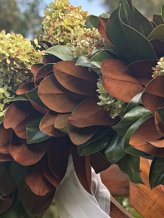 Magnolia & green hydrangea on the ceremony arch